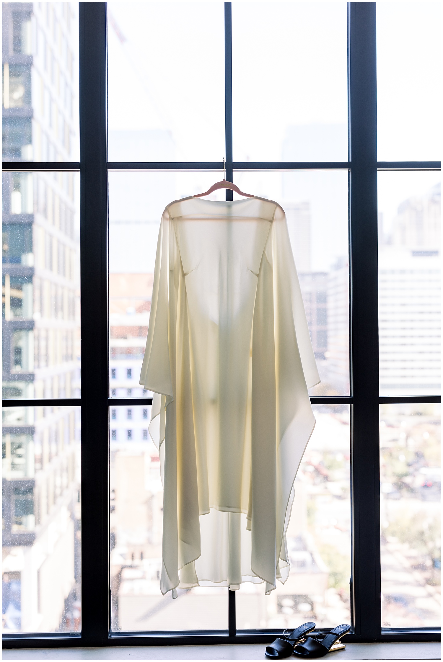 Wedding dress hanging in a window